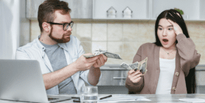 man and woman holding cash
